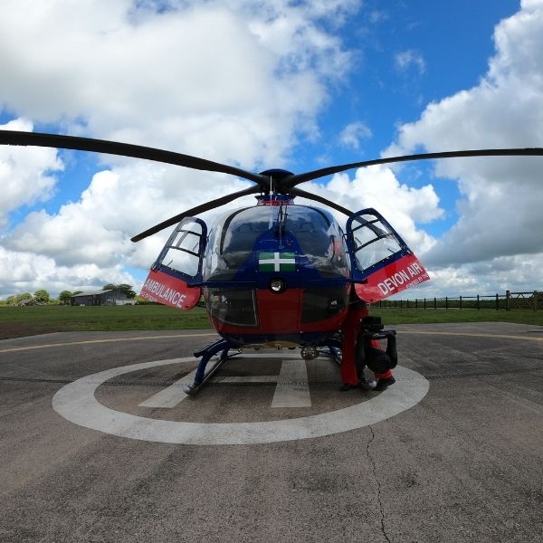 Aircraft with doors open on helipad